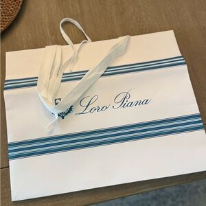 Loro Piana White Bag with Blue Stripes paper bag.